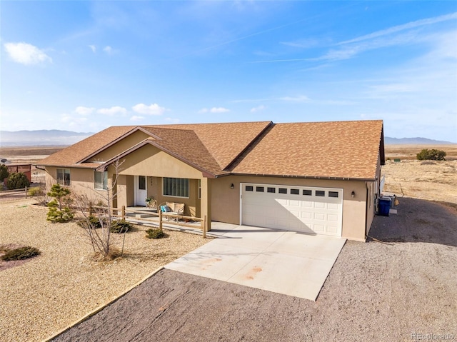 single story home with a mountain view and a garage