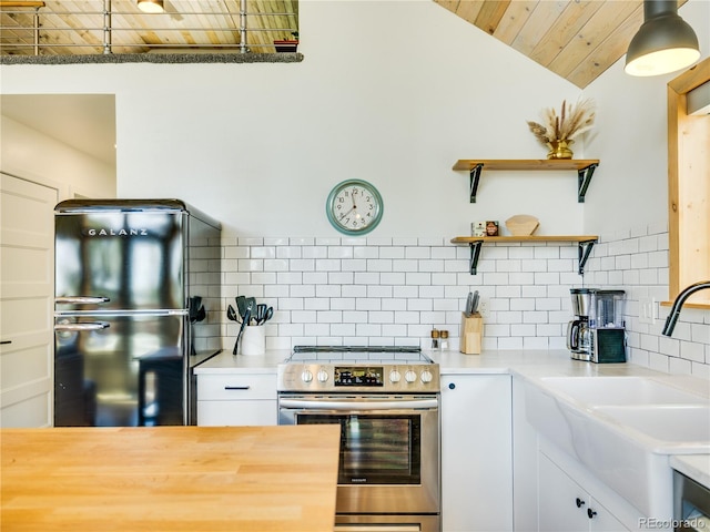 2946 Middle Fork Vis, Fairplay, CO 80440 - kitchen featuring stainless steel range with electric cooktop, freestanding refrigerator, wood ceiling, backsplash, and vaulted ceiling