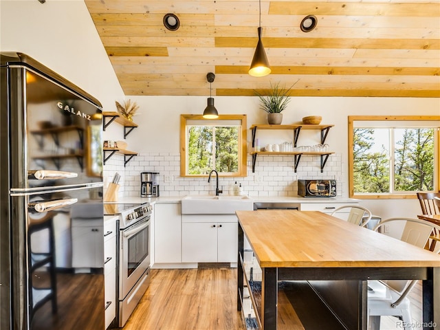 2946 Middle Fork Vis, Fairplay, CO 80440 - kitchen with open shelves, stainless steel range with electric cooktop, freestanding refrigerator, wooden ceiling, and wood counters