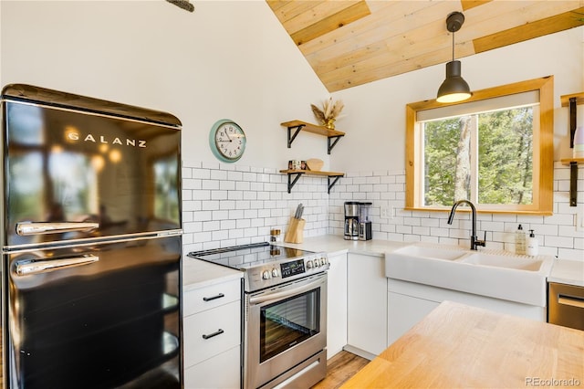 2946 Middle Fork Vis, Fairplay, CO 80440 - kitchen featuring stainless steel appliances, light countertops, lofted ceiling, backsplash, and white cabinets