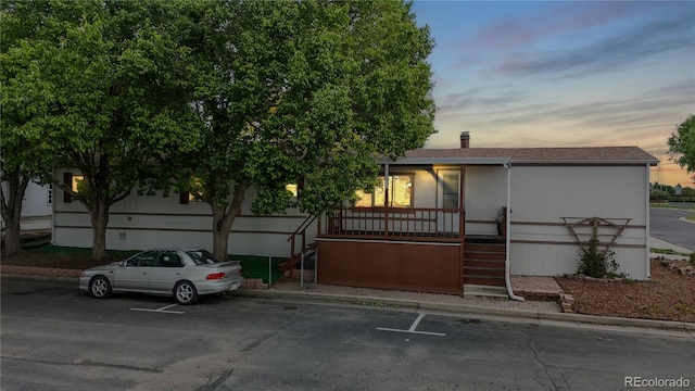 8509 Colorado Ct, Denver, CO 80229 - view of front of home featuring stairway, covered porch, and uncovered parking