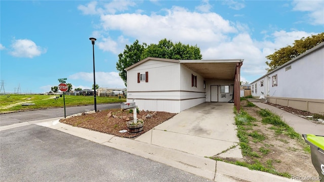 8509 Colorado Ct, Denver, CO 80229 - manufactured / mobile home featuring concrete driveway and an attached carport