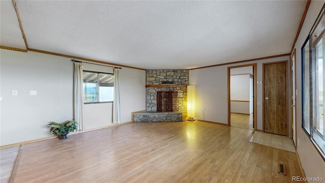 8509 Colorado Ct, Denver, CO 80229 - unfurnished living room with ornamental molding, a textured ceiling, wood finished floors, a fireplace, and baseboards