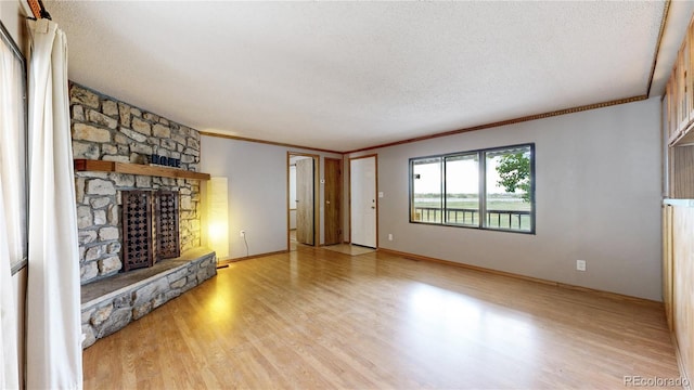 8509 Colorado Ct, Denver, CO 80229 - unfurnished living room with wood finished floors, ornamental molding, a stone fireplace, and a textured ceiling