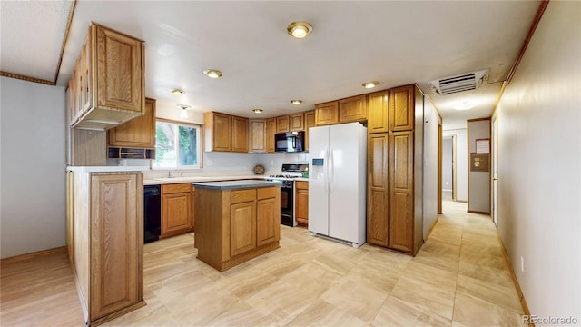 8509 Colorado Ct, Denver, CO 80229 - kitchen with black appliances, a kitchen island, brown cabinetry, and baseboards