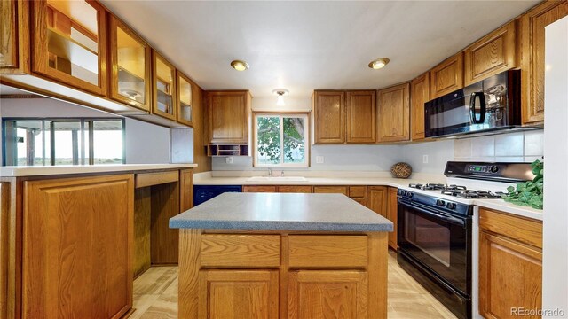 8509 Colorado Ct, Denver, CO 80229 - kitchen featuring range with gas cooktop, black microwave, a sink, and brown cabinets