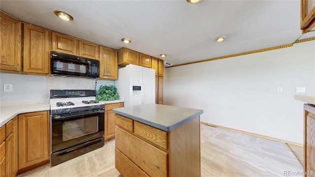 8509 Colorado Ct, Denver, CO 80229 - kitchen featuring range with gas stovetop, black microwave, white fridge with ice dispenser, a kitchen island, and recessed lighting