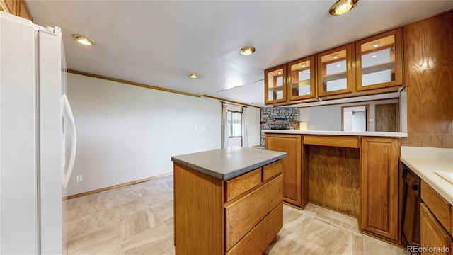8509 Colorado Ct, Denver, CO 80229 - kitchen with brown cabinetry, freestanding refrigerator, glass insert cabinets, a center island, and recessed lighting