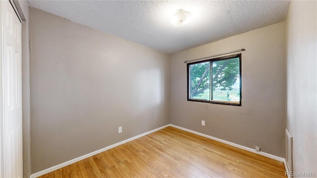 8509 Colorado Ct, Denver, CO 80229 - unfurnished room featuring light wood-style flooring, baseboards, and a textured ceiling