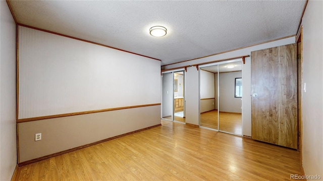 8509 Colorado Ct, Denver, CO 80229 - spare room with light wood finished floors, a textured ceiling, ornamental molding, and baseboards