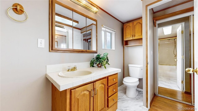 8509 Colorado Ct, Denver, CO 80229 - bathroom with vanity, toilet, a shower, baseboards, and ornamental molding