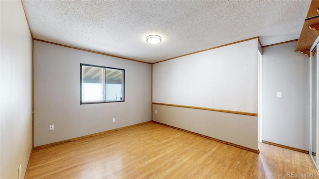 8509 Colorado Ct, Denver, CO 80229 - empty room featuring crown molding, wood finished floors, and a textured ceiling