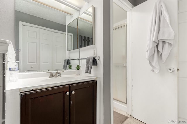 bathroom featuring vanity and a shower with shower door