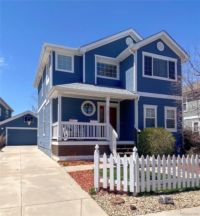 traditional home with covered porch, a fenced front yard, and an outdoor structure