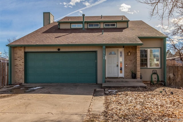 view of front of house featuring an attached garage, a chimney, concrete driveway, and brick siding