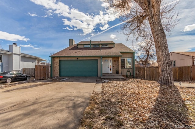 view of front facade with driveway, a chimney, a garage, and fence