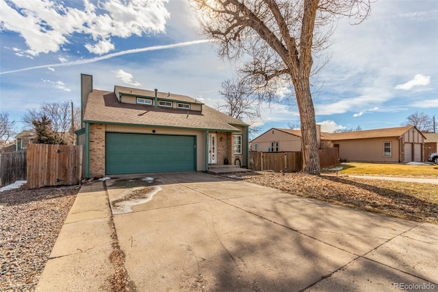 view of front of house with driveway, fence, and brick siding