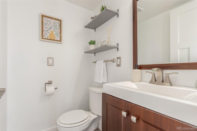 bathroom with toilet, visible vents, and vanity