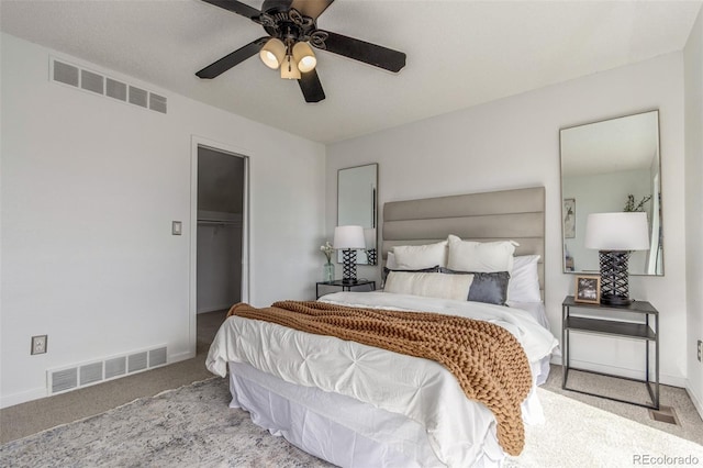 bedroom featuring baseboards, visible vents, a closet, and light colored carpet