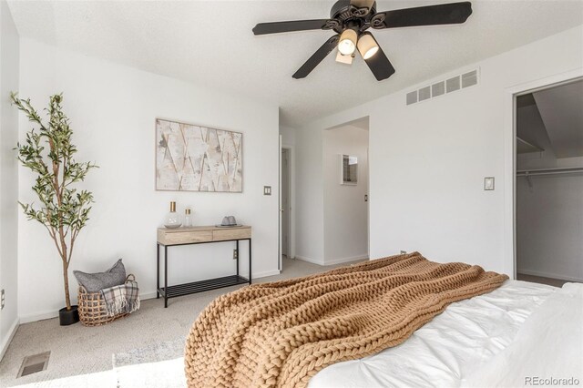 bedroom featuring a ceiling fan, carpet, visible vents, and a closet