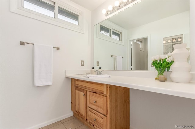 bathroom featuring tile patterned floors, baseboards, and vanity