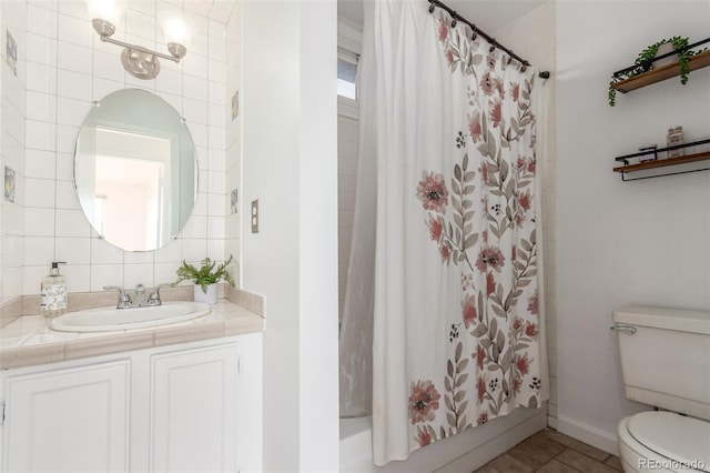 bathroom with toilet, vanity, baseboards, tile patterned floors, and shower / bath combo with shower curtain