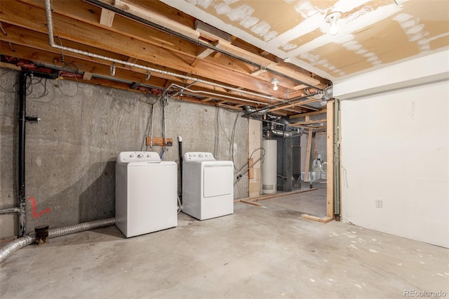 unfinished basement with washer and clothes dryer and gas water heater