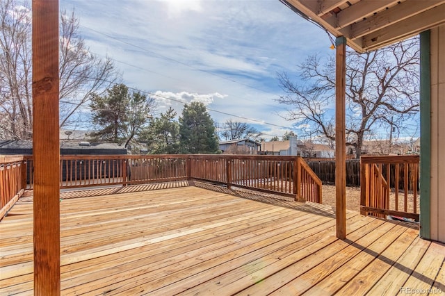 wooden terrace featuring fence