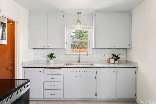 1638 N Foote Ave, Colorado Springs, CO 80909 - kitchen with light countertops, decorative backsplash, and a sink