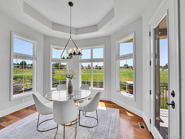 2131 Driver Ln, Erie, CO 80516 - dining space with a raised ceiling, a chandelier, and wood finished floors