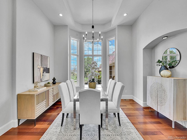 2131 Driver Ln, Erie, CO 80516 - dining space with a chandelier, wood finished floors, recessed lighting, a high ceiling, and a raised ceiling