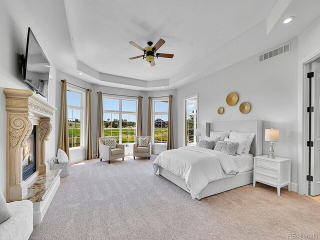 2131 Driver Ln, Erie, CO 80516 - bedroom with a high end fireplace, a raised ceiling, carpet, recessed lighting, and a ceiling fan