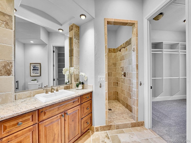 2131 Driver Ln, Erie, CO 80516 - full bathroom with vanity, a tile shower, stone finish flooring, and a closet