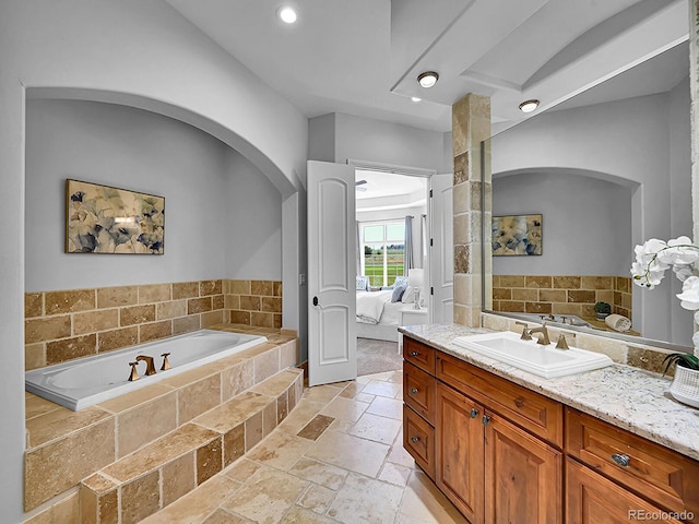 2131 Driver Ln, Erie, CO 80516 - bathroom featuring a bath, connected bathroom, stone tile flooring, vanity, and recessed lighting