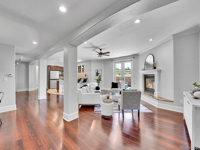 2131 Driver Ln, Erie, CO 80516 - living room with wood finished floors, arched walkways, recessed lighting, ceiling fan, and ornamental molding