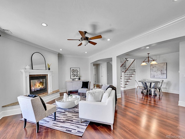 2131 Driver Ln, Erie, CO 80516 - living area with stairway, arched walkways, recessed lighting, ceiling fan, and a glass covered fireplace
