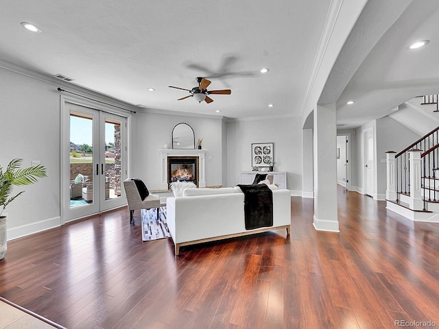 2131 Driver Ln, Erie, CO 80516 - living area featuring a ceiling fan, stairs, crown molding, wood finished floors, and arched walkways