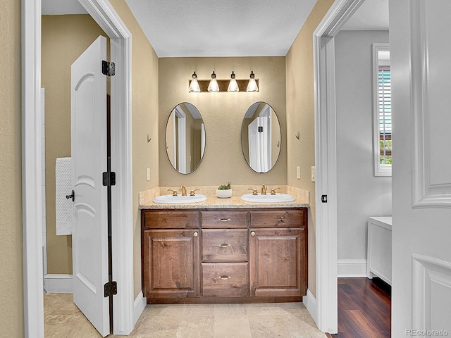 2131 Driver Ln, Erie, CO 80516 - full bathroom featuring double vanity and baseboards