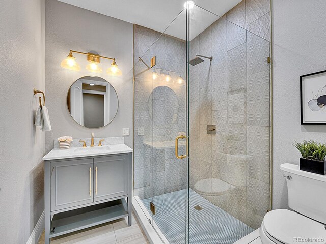 2131 Driver Ln, Erie, CO 80516 - bathroom featuring vanity, a stall shower, tile patterned floors, and a textured wall