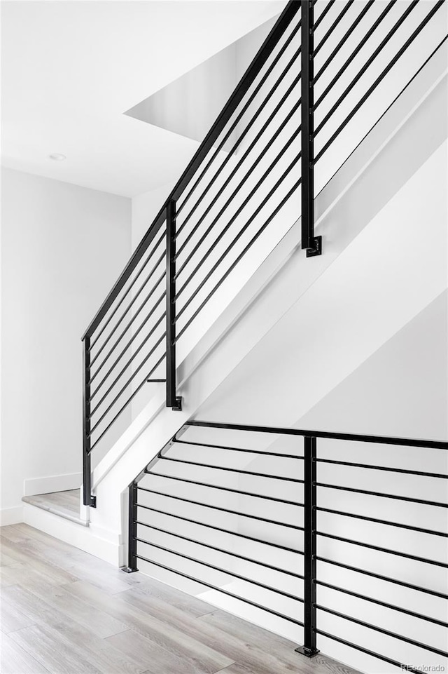 staircase featuring hardwood / wood-style flooring