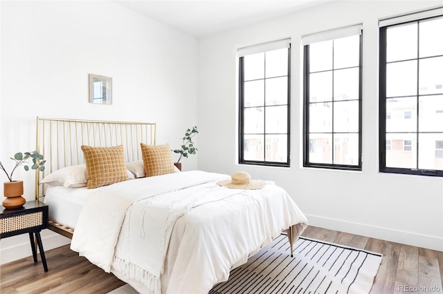 bedroom with wood-type flooring