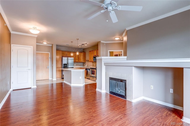 10184 Park Meadows Dr Unit 1317, Lone Tree, CO 80124 - unfurnished living room with wood finished floors, a ceiling fan, ornamental molding, and a tile fireplace