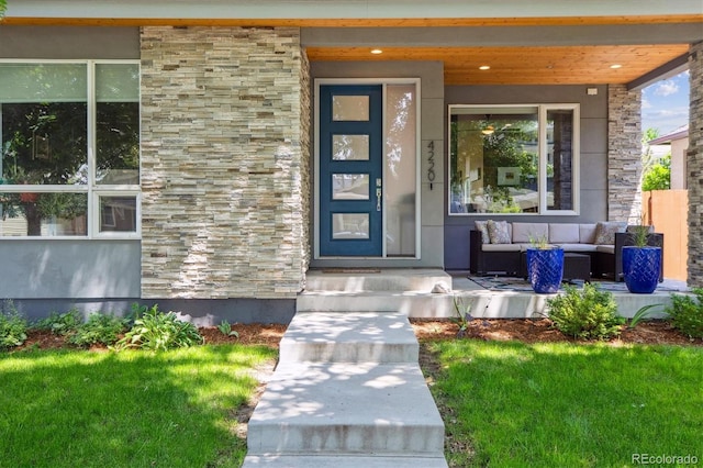 4220 Quitman St, Denver, CO 80212 - entrance to property featuring stone siding, covered porch, an outdoor living space, and a yard