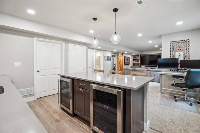 4220 Quitman St, Denver, CO 80212 - kitchen with wine cooler, dark brown cabinets, light countertops, recessed lighting, and a center island