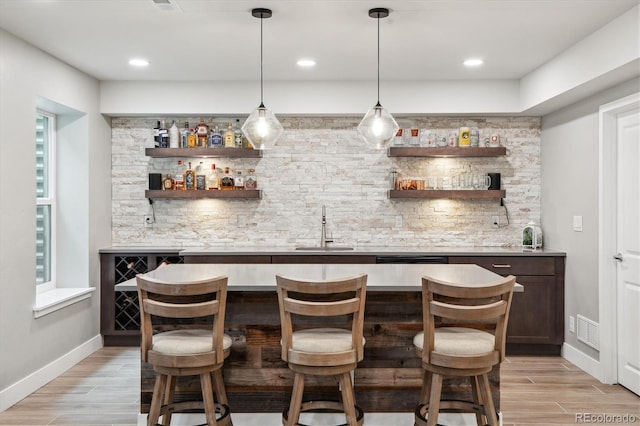4220 Quitman St, Denver, CO 80212 - indoor wet bar featuring backsplash, light wood-type flooring, hanging light fixtures, and recessed lighting