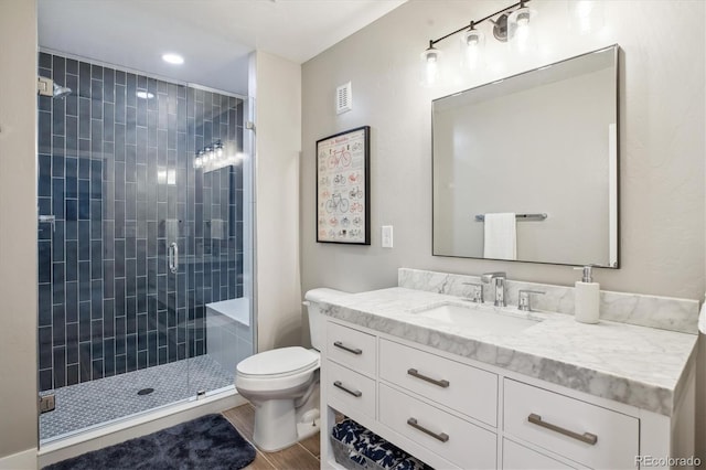 4220 Quitman St, Denver, CO 80212 - full bath featuring vanity, a shower stall, wood finished floors, and recessed lighting