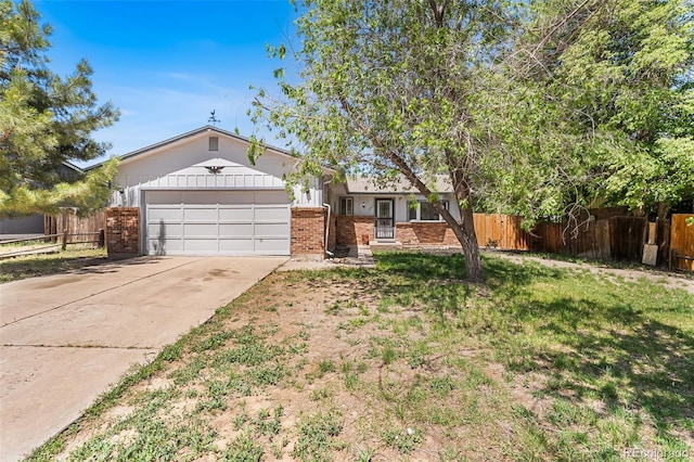 12829 E Nevada Ave, Aurora, CO 80012 - ranch-style house featuring brick siding, an attached garage, and concrete driveway