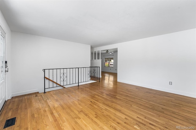 12829 E Nevada Ave, Aurora, CO 80012 - spare room with light wood finished floors, a ceiling fan, and baseboards