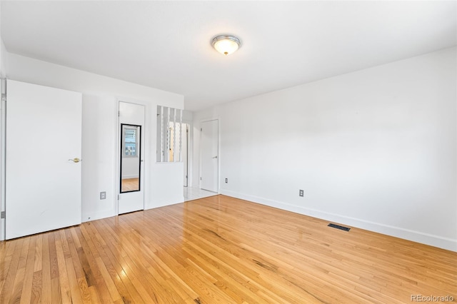 12829 E Nevada Ave, Aurora, CO 80012 - unfurnished bedroom with light wood finished floors and baseboards