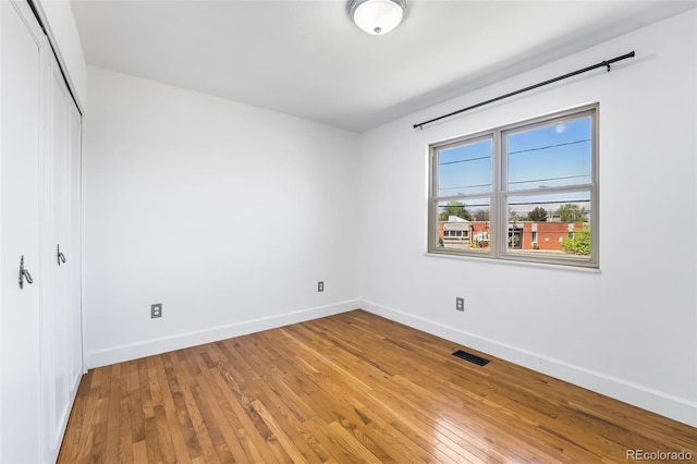 12829 E Nevada Ave, Aurora, CO 80012 - unfurnished bedroom featuring baseboards, a closet, and wood-type flooring